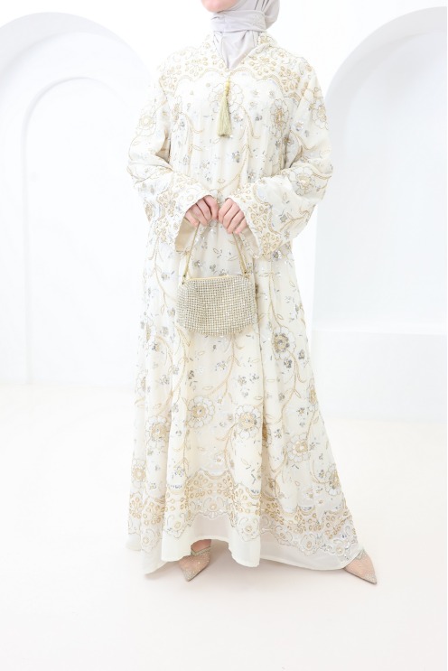 Beige caftan-style dress with embroidery and beads, perfect for Eid
