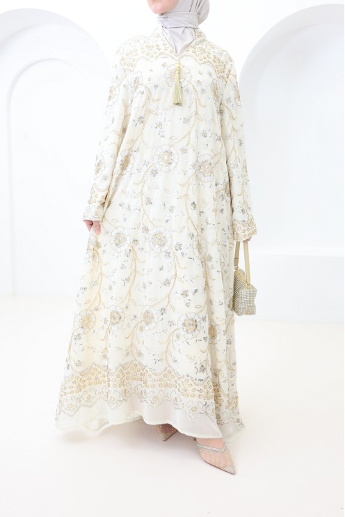 Beige caftan-style dress with embroidery and beads, perfect for Eid