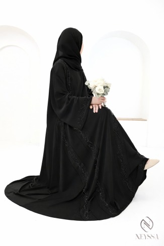 Veiled woman's black Dubai abaya embroidered beads and rhinestones